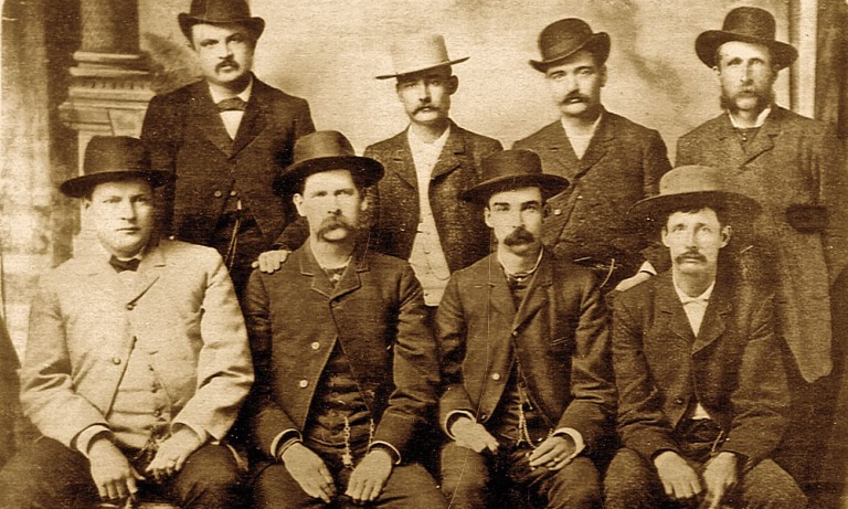 Dodge City Peace Commission, early June, 1883. The men went to Dodge armed to support Luke Short in a confrontation with business interests that wanted to force him out of town. The title of "peace commission" (later applied to the photo) was ironic. Their presence did produce a peaceful resolution. According to a biography of Wyatt Earp by Casey Tefertiller, the photo was taken in the Conkling Studio at Dodge City in June 1883 and first appeared in the National Police Gazette on 21 July, 1883. From left to right, standing: W.H. Harris, Luke Short, Bat Masterson, W.F. Petillon. Seated: Charlie Bassett, Wyatt Earp, Frank McLain (possibly "M. C. Clark"; see Dodge City Peace Commission), and Neal Brown It's a "published pre-1923" historical photo, so the release should read that. Sbharris 21:36, 3 March 2006 (UTC)
