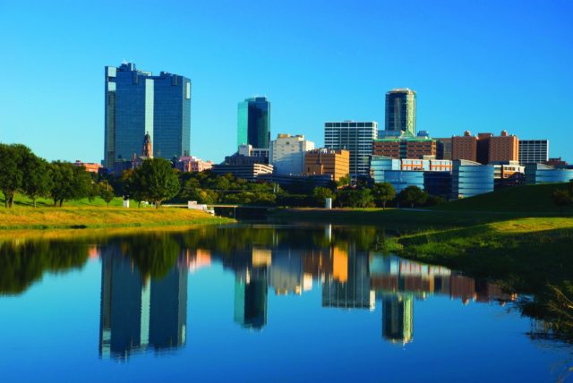 Fort Worth skyline with the Trinity River in the foreground.