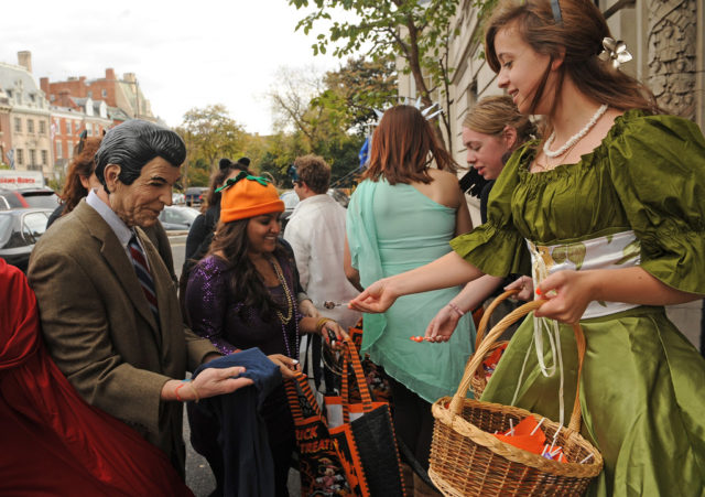 WASHINGTON, DC - OCTOBER 29: Niamh McCabe, far right, and her sister Kelly, second right, hand out candy to trick-or-treating college students at the Irish Embassy on October 29, 2010 in Washington, D.C. Over a dozen embassies in the district participated in the pre-Halloween event where many international local college students got to trick-or-treat. (Photo by Ricky Carioti/The Washington Post)