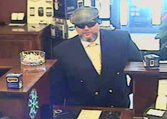 File-A file image provided by the Jackson, Wyo., Police Department shows Corey Donaldson, a 39-year-old Australian, during a bank robbery on New Yearís Eve, 2012, at the U.S. Bank in Jackson, Wyo.  Donaldson is standing trial in Wyoming says he was justified in robbing a Jackson bank because he gave the money to the homeless.    (AP Photo/Jackson Police  Department,File)